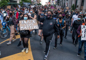Large crowd of dmonstrators with signs for Black Lives Matter.