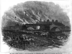 Black and gray illustration of building with smoke billowing into the air. Mangled railroad tracks and broken wheels and axels are visible in the foreground.