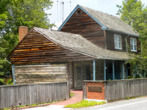 photograph of the outside of a log cabin house
