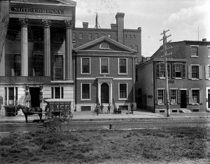 a black and white photograph of the Philadelphia Dispensary, a two story building