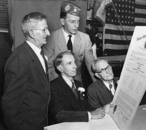 VFW Commander Robert Hassler reading the charter of the Camp 13 chapter of the United Spanish War Veterans to its three remaining members.