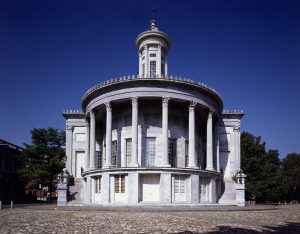 A color photograph of the Merchants' Exchange building showing Greek-style columns on a large front portico.